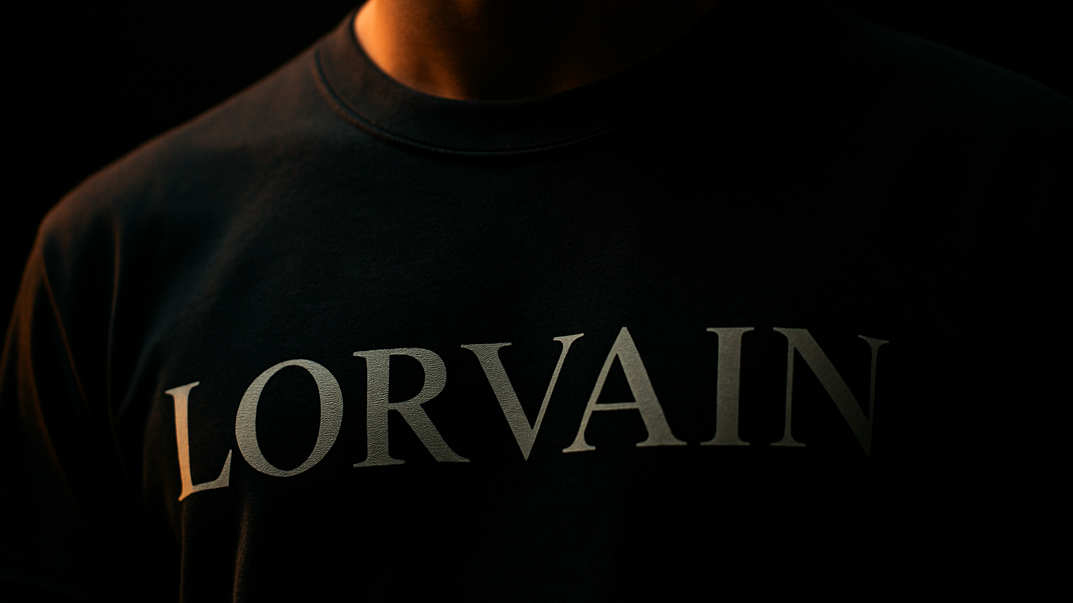 Close-up shot of chest area wearing Lorvain t-shirt with partial logo visible